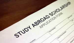 Someone filling out Study Abroad Scholarship Application Form.